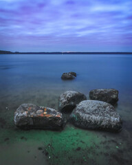 dusk over the lake with stones