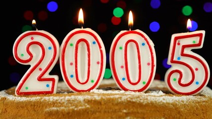 Birthday cake with white burning candles in the form of number 2005