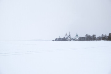 Fototapeta na wymiar Frozen lake in the snow. Temple Monastery. Rostov