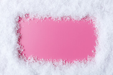 Pink background with copy space in snowy frame. New Year and Christmas design