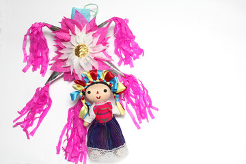 Mexican handmade piñata of clay and colored paper to celebrate posadas and Christmas with doll, canes and poinsettia flowers
