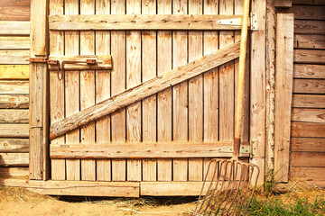 Wooden door to the barn or horse stall, lock on the door.