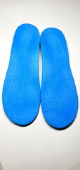 Individual orthopedic insoles for shoes in blue. Children's insoles for foot correction. Medical insoles.