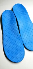 Individual orthopedic insoles for shoes in blue. Children's insoles for foot correction. Medical insoles.
