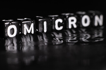 SARS-CoV-2 Coronavirus Variant Omicron. OMICRON name reveal. Red and black background.