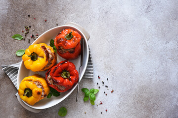 Stuffed pepper. Paprika with rice and minced meat. Baked peppers on a concrete background..Top view.