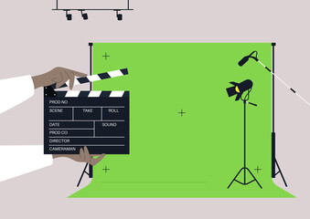 A movie set with a chroma key screen, lighting equipment, microphones, and a clapper board - obrazy, fototapety, plakaty