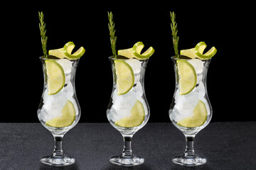 three glass with ice and lemon ingredients for drinks and cocktails