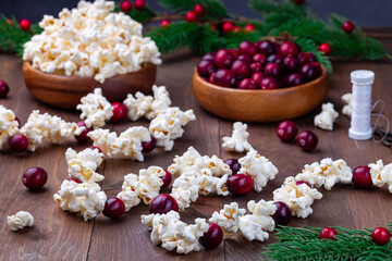 Traditional handcrafted Christmas popcorn garland with red cranberries, horizontal - obrazy, fototapety, plakaty