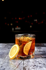 cocktail in a transparent glass with a starry black background