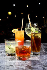 cocktail in a transparent glass with a starry black background