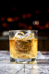 cocktail in a transparent glass with a starry black background