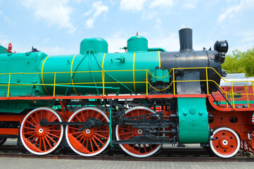 Old steam locomotive 1935-1957 Green with red wheels. Renovated, it stands on the railway as a museum piece.