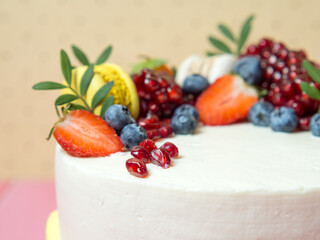 beautiful birthday cake decorated with berries with place for text