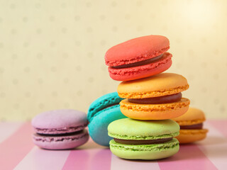 Fresh baked colored macaroon cookies macarons, macarons on a white plate close-up,