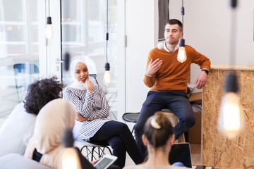 Young successful people brainstorming at a creative meeting.
