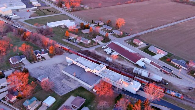 The Sun's first rays illuminate a freight train as it speeds across the rural landscape, leaving Wrightstown bound for Green Bay, Wisconsin.