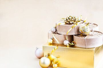 Christmas or New year round kraft gift boxes, gold holiday balls on a bokeh background of twinkling...