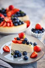 Vanilla New York cheesecake decorated with fresh blueberries and strawberries