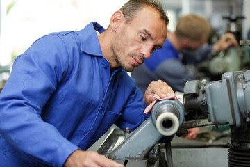 engineer maintaining machinery in factory