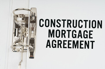 In the folder under a paper clip there is a white sheet with the inscription - Construction Mortgage agreement