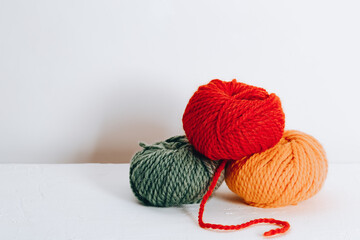 Balls of wool for knitting in autumn colors on a white background