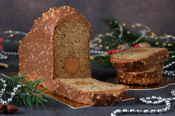 Christmas cake with hazelnuts and salted caramel, covered with chocolate glaze with nuts