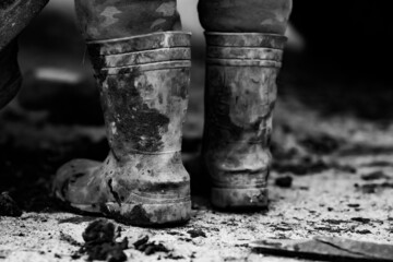 Black and white boots - Dirty work and labour concept