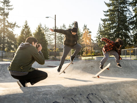 Young Indigenous male photographer, non-binary skater and father outdoors