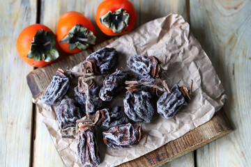 Selective focus. Macro. Dried persimmon on a wooden surface.