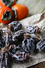 Selective focus. Macro. Dried persimmon on a wooden surface.
