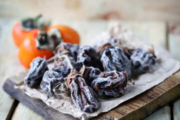 Selective focus. Macro. Dried persimmon on a wooden surface.