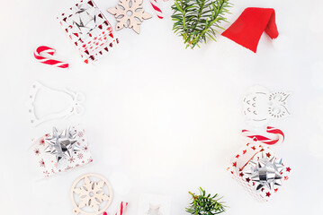 New Year gifts.Christmas and New Year background. Bright Winter holiday composition. Gifts, spruce branches, red decorations on a white background.Greeting card, banner, poster.Christmas composition.