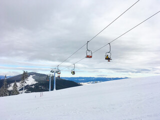 Fototapeta na wymiar Ski resort chairlift snow mountains