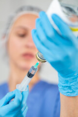 Portrait of a nurse with a syringe preparing for vaccination
