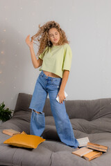 girl student has taken break from preparing for exams and is dancing and having fun among the books...