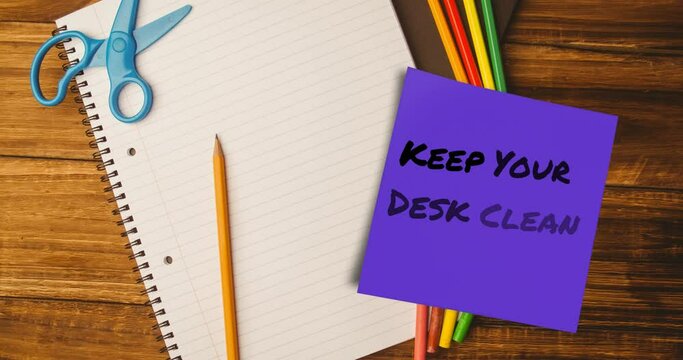 Animation of keep your desk clean text on memo note over notebook and pencils on desk - Powered by Adobe