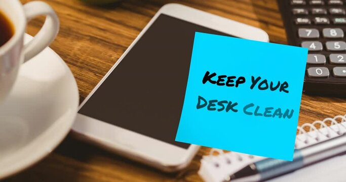 Animation of keep your desk clean text on memo note over smartphone on desk