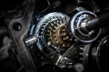 Car transmission, gearbox with visible gears and cogs in the garage.
