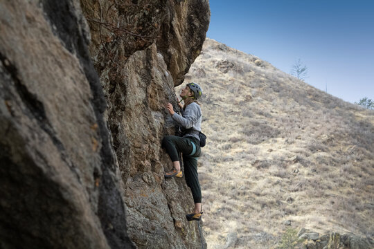 Female rock climber in Colorado takes on a challenging climb.