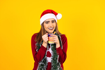 latin christmas woman with a clay mug of coffee or fruit punch on yellow background in mexico latin america