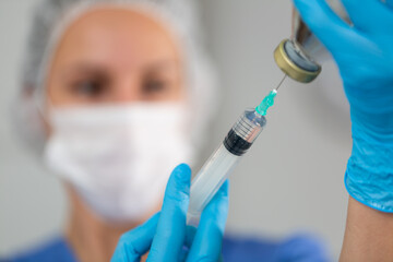 Female nurse ready to make injection in hospital