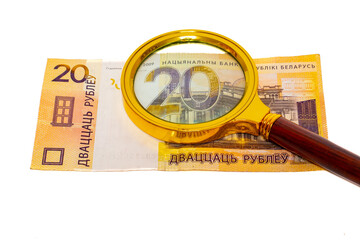 20 Belarusian rubles under a magnifying glass isolated on white background