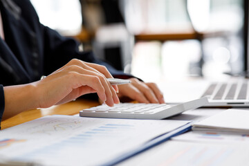 Businesswoman working at office with documents on his desk, doing planning analyzing the financial...