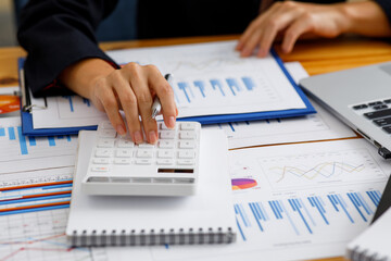 Businesswoman working at office with documents on his desk, doing planning analyzing the financial report, business plan investment, finance analysis concept
