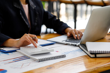 Businesswoman working at office with documents on his desk, doing planning analyzing the financial report, business plan investment, finance analysis concept