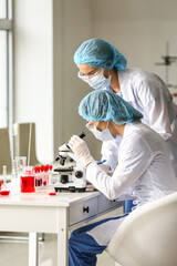 Scientists studying sample in laboratory