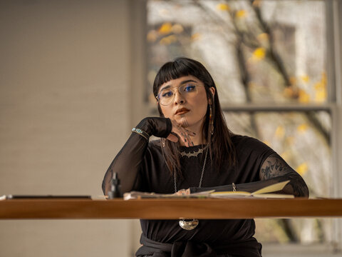 Non binary Indigenous artist drawing indoors