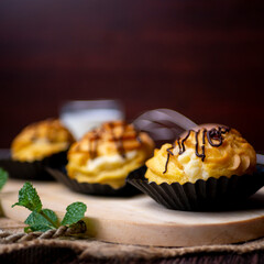 Kue soes coklat, soes coklat, chocolate cream puffs or famous with Choux Pastry Cream Puffs, pastry ball filled with white cream
