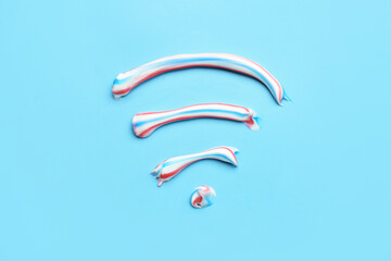 WiFi symbol made from toothpaste on blue background